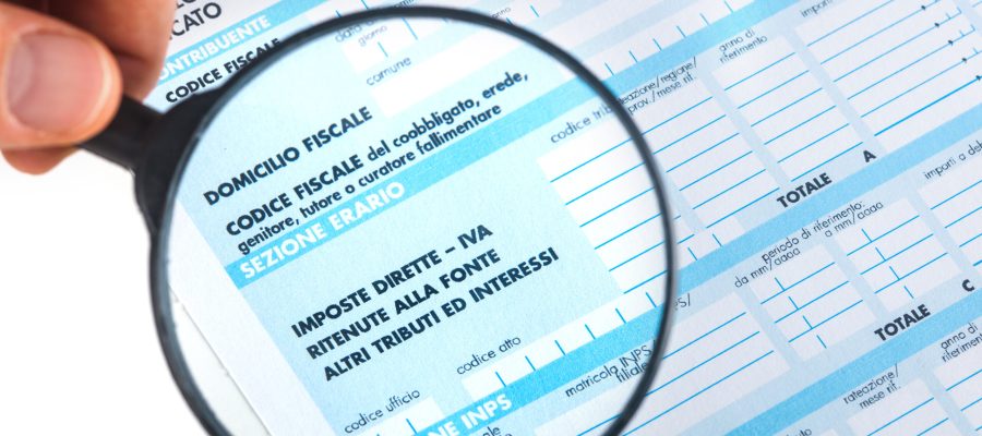 F24 for the tax return in Italy with magnifying glass.